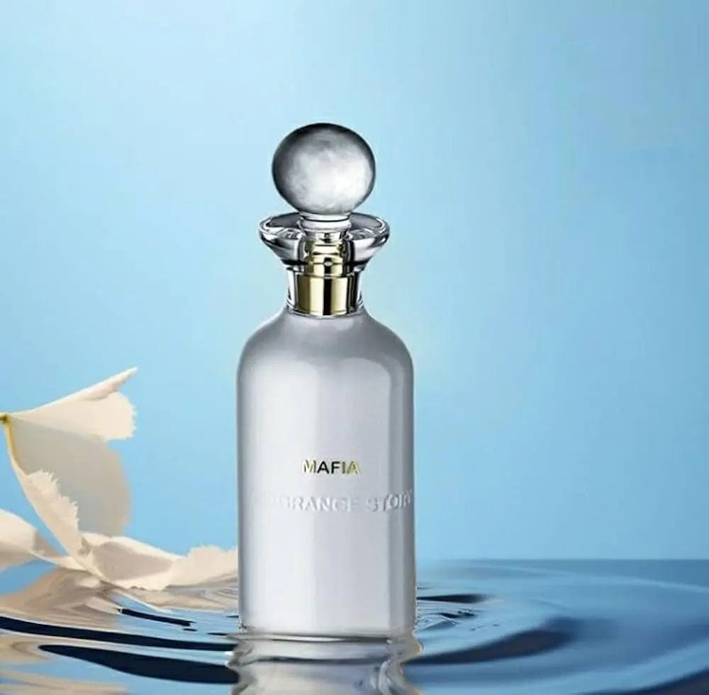 A stylized photo of the minimalist white Fragrance Story Mafia bottle, with its spherical cap, resting in clear water against a blue background.